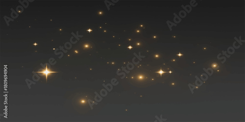 Bright, shiny celebration fireworks explode in the dark night sky with a magical, starry glow