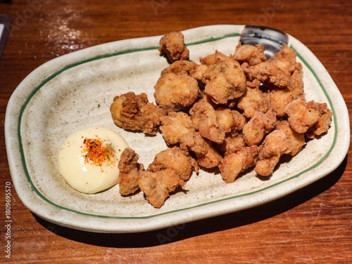 close up of Japanese deep fried chicken soft bone (Chicken cartilage) with mayonnaise on the side 
