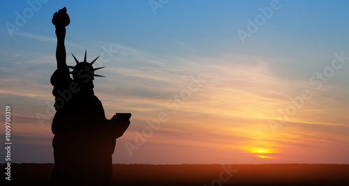 Statue of Liberty on background of sunset sky. Close-up. Greeting card for Independence Day. USA celebration.