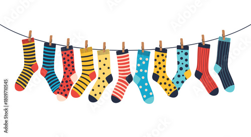 A cheerful collection of colorful and patterned socks hanging on a clothesline with clothespins to dry on white.
