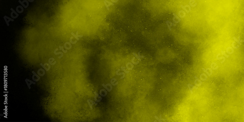 Yellow color powder explosion cloud isolated on black background.  dust smoke . Yellow dust particles explosion background .