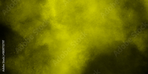 Yellow color powder explosion cloud isolated on black background.  dust smoke . Yellow dust particles explosion background .