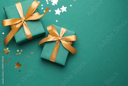 Beautiful Christmas composition with gifts and decor on teal background, flat lay. Space for text © New Africa