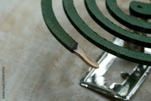 Quadro em tela The spiral shape of a green mosquito coil, partially burned and resting on its metal stand