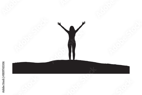 Silhouette of a woman with arms raised in triumph on a hilltop