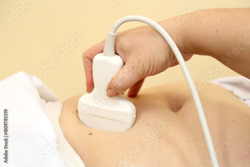 Modern ultrasound device. Ultrasound examination of internal organs. A woman undergoing an ultrasound scan of her abdominal cavity. Ultrasound examination device.   