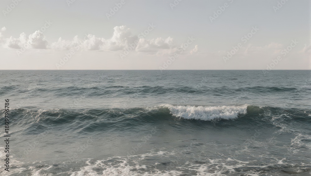 Fototapeta premium Calm Ocean Waves Under a Cloudy Sky.