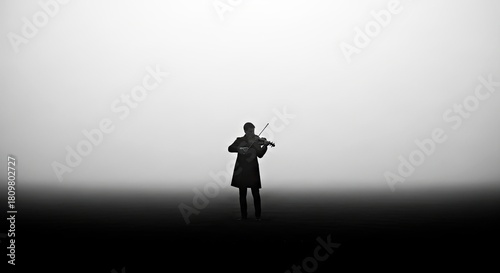 Silhouette of Violinist Playing in Misty Field Black and White