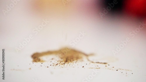 black pepper on bright surface, pile of pepper grains on white tabletop, closeup of pepper granules with soft background, detailed shot of aromatic black pepper scattered across smooth white surface
