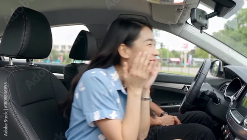 Young Asian Woman Reacts with Surprise and Excitement While Riding in a Car with a Male Driver.