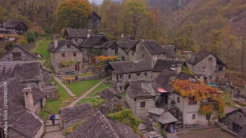Aerial shot of Foroglio village glowing with autumn shades, Ticino.