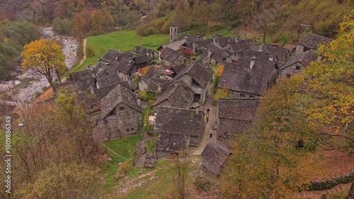 Historic Foroglio nestled in a fall-colored valley, aerial view, Ticino.