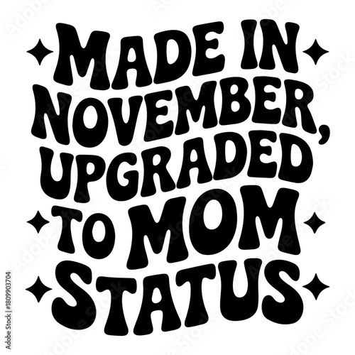 Made in november upgraded to mom status in black retro font with stars on a white background design image