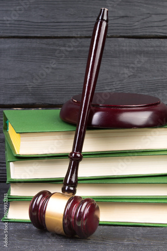 Law concept - Open law book with a wooden judges gavel on table in a courtroom or law enforcement office isolated on white background. Copy space for text.
