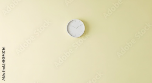 Minimalist oval wall clock on a soft yellow background