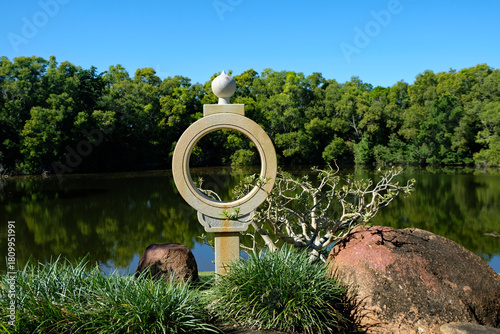 Looking at a pond through a stone garden symbol.