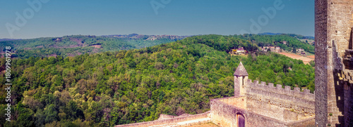 Panoramic view of the stone ramparts and surrounding countryside of a castle in Dordogne