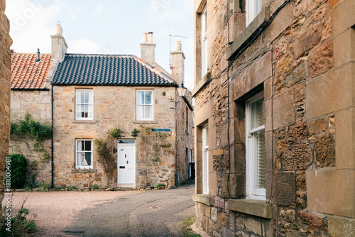 Charming old stone buildings along a narrow quiet street in a traditional village setting