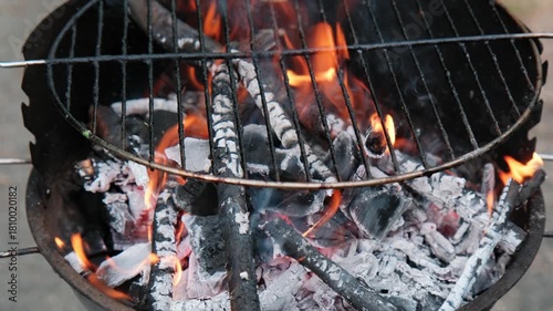 Charcoal grill with burning coals. Closeup of burning coals in a fireplace or barbecue grill.