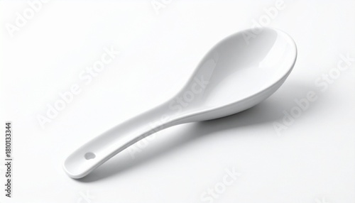White ceramic Chinese soup spoon on white surface with subtle reflection