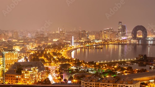 Baku Azerbaijan night cityscape timelapse - city lights on the waterfront during day to night transition. Aerial panorama of the capital's downtown and famous tourist destination on the Caspian sea.
