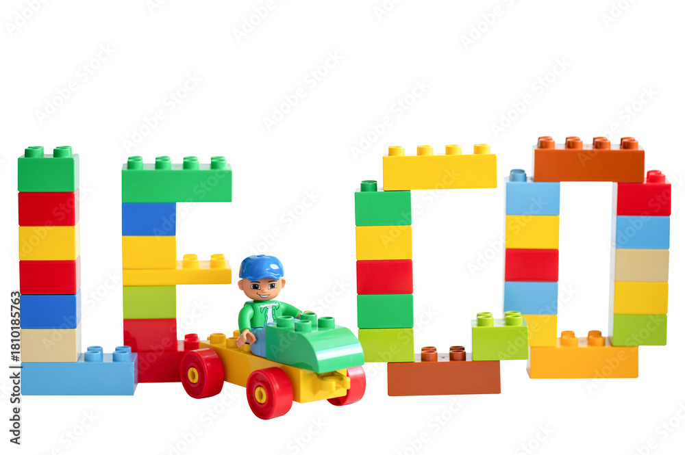 Naklejka premium The word LEGO made of multicolored bricks and a minifigure of a person on a car. LEGO Duplo bricks. Educational toys for toddlers.