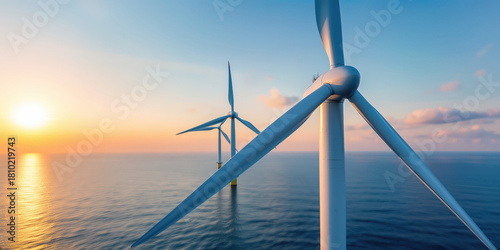 Offshore wind turbines generating clean energy at sunset