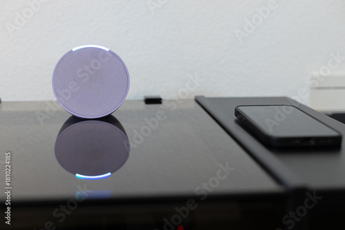 person controls smart wireless device with cell phone at home