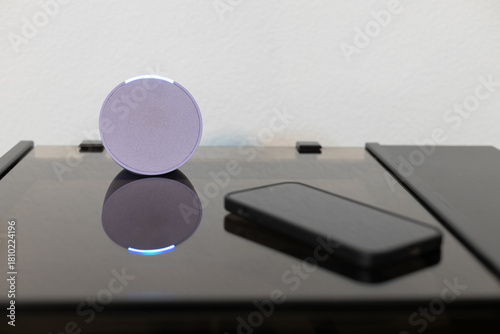 person controls smart wireless device with cell phone at home