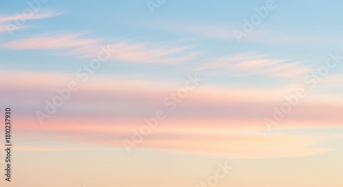 Fototapeta Naklejka Na Ścianę i Meble -  A tranquil landscape at sunset, featuring a serene sky with pastel-colored clouds and a warm, glowing horizon. The scene evokes a sense of peace and calm.
