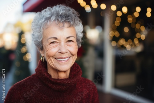 Senior woman smiling happily in a festive outdoor setting