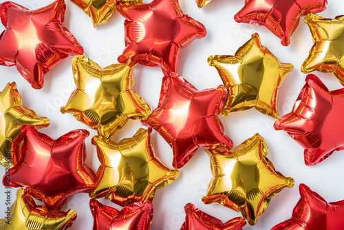Colorful star-shaped balloons create a festive atmosphere for celebrations and events in bright red and gold tones