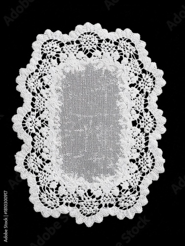 Rectangular white lace doily with scalloped border on black background