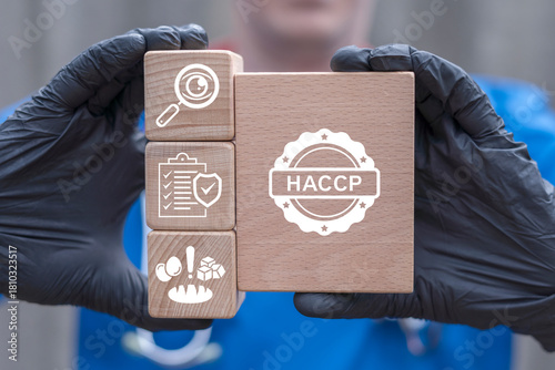 Foto Doctor holding wooden blocks with icons sees the acronym HACCP