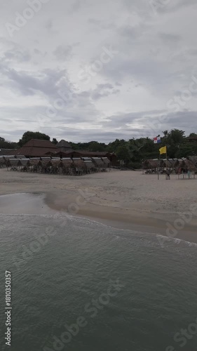 Aerial video taken with a drone in vertical format on Santa Clara beach on a cloudy day by the Pacific Ocean, in the province of Coclé, in Río Hato, Panama.