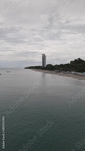 Aerial video taken with a drone in vertical format on Santa Clara beach on a cloudy day by the Pacific Ocean, in the province of Coclé, in Río Hato, Panama.