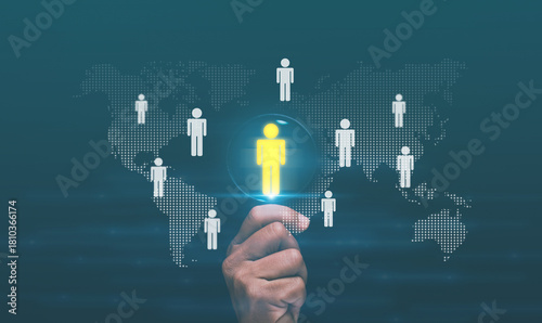 Human resources management concept. Manager holding magnifying glass with highlighted person icon. Recruitment, team management and international talent connection in modern digital business.