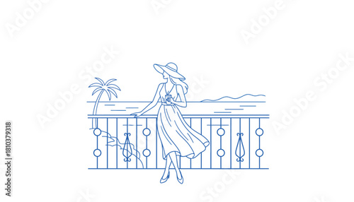 Elegant woman in a flowing dress and hat enjoys a drink on a balcony overlooking the ocean and palm tree