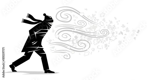Silhouette of a person struggling against the biting wind and a blizzard winter season