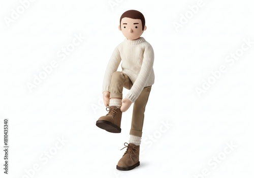 Stuffed doll of a man bending down to tie the laces on his winter boots, symbolizing preparation, winter fashion, and outdoor activity