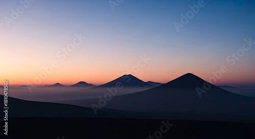 Beautiful sunrise over the mountains, with soft light and fog creating a serene and peaceful landscape