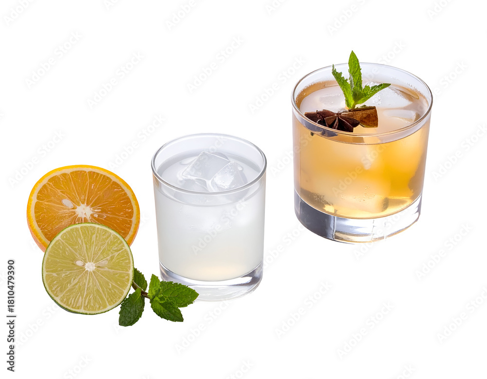 Fototapeta premium A refreshing citrus cocktail garnished with mint and chocolate pieces alongside fresh citrus slices and a glass of clear beverage