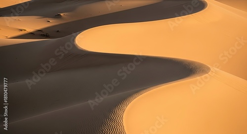 Fototapeta Naklejka Na Ścianę i Meble -  Dramatic view of sand dune with a sharp ridge line casting shadows in the desert landscape