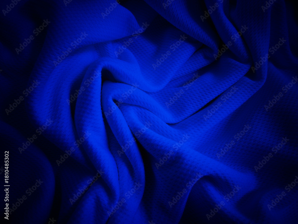 Obraz premium Crumpled dark blue fabric background. Wavy cloth