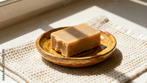 Traditional soap bar on a rustic plate, bath time essentials