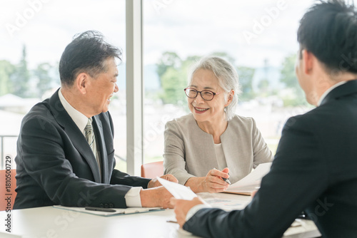 An elderly couple reviewing the proposed documents (asset management, consultation, investment, inheritance)
