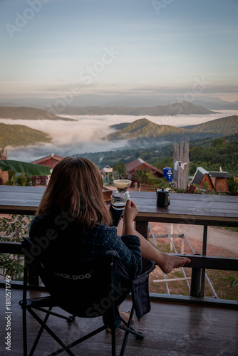 Woman Drinking Coffee with Mountain View