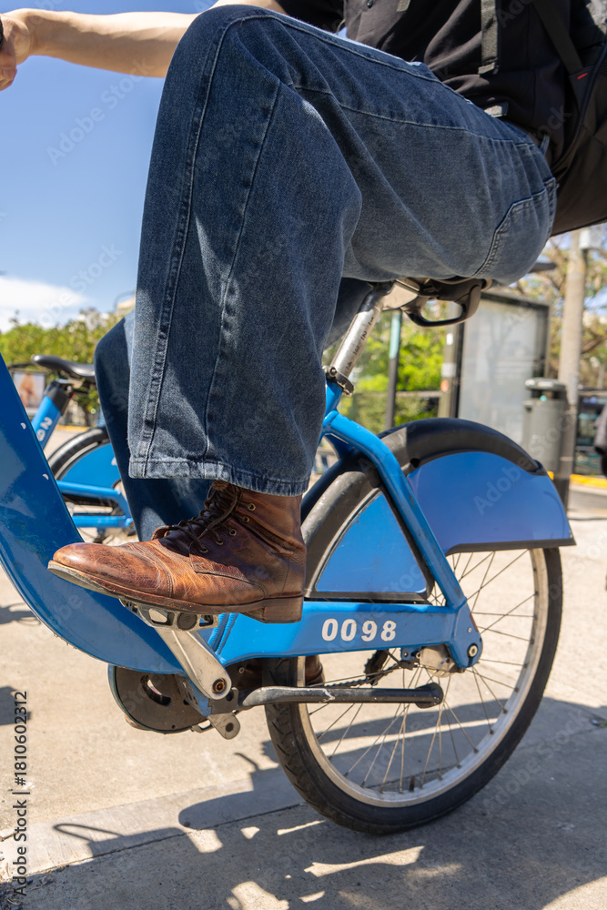 Fototapeta premium Man riding rental bike in city street
