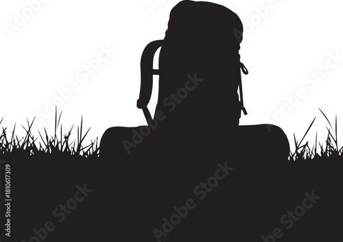 Black silhouette of a backpack on grass white