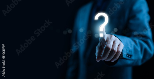 Bild auf Leinwand A businessman pointing at a glowing question mark icon symbolizing uncertainty decision-making inquiry problem-solving, and strategic planning in modern digital business and professional environments